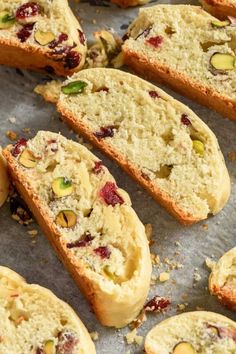 several pieces of bread with nuts and cranberry toppings