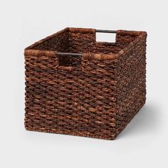 a brown wicker basket with handles