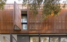 an apartment building with wooden slats on the side