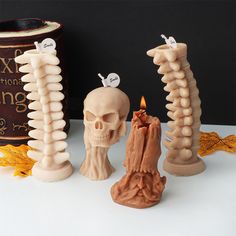 there are three candles that look like human bones and one has a candle in it