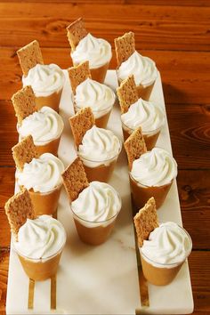 cupcakes with white frosting and graham crackers on a platter ready to be eaten