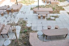 an outdoor seating area with tables and benches