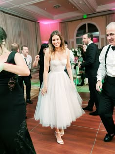 a bride and groom are dancing on the dance floor