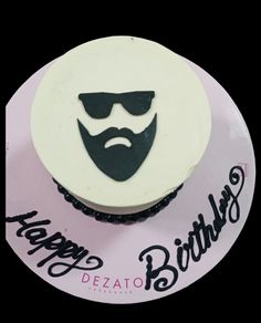 a birthday cupcake with a mustache and sunglasses on it