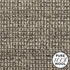 a close up view of the texture of a wool carpet with white and grey colors