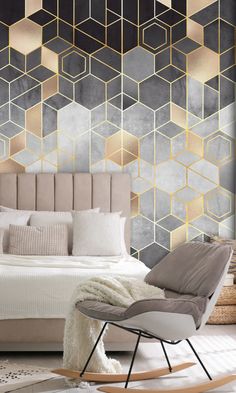 a modern bedroom with gold and grey hexagonal wallpaper, a rocking chair, and a bed