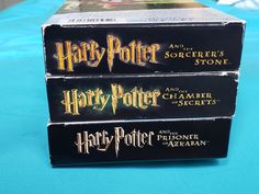 three harry potter books stacked on top of each other in front of a blue background