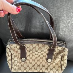 This Preowned Gucci Gg Monogram Boston Handbag Is In Amazing Condition With Very Faint Scratching Which Is Practically Not Noticeable. Please Refer To All Photos For Details. The Bag Is Made Out Of The Classic Gg Monogram Canvas With Tall Mocha Leather Strap Top Handles, Base, And Trim. The Hardware Is Gold Tone; Which Includes Handles Rings And Decorative "Bolt" Charms On Each Handle. The Closure Is Zipper Top. The Interior Is A Dark Brown Textile Fabric With Room For Everyday Essentials With The Sophisticated Style Of Gucci! Preowned Gucci Gg Monogram Boston Handbag Exterior: Very Gently Used, No Signs Of Wear Interior: No Bad Odor. Brown Leather Strap Top Handles, Base And Trim Gol Gg Monogram, Brown Leather Strap, Strap Top, Zipper Top, Strap Tops, Textile Fabrics, Sophisticated Style, Monogram Canvas, Mocha