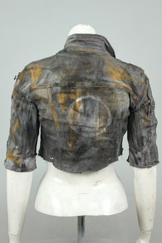 an old jean jacket is displayed on a mannequin's head and torso