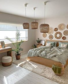 a bed room with a neatly made bed and lots of hanging baskets on the wall