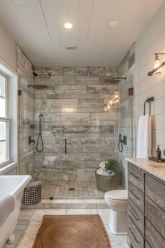 a bathroom with a toilet, sink, and shower stall in it's center