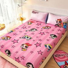 a pink bed with cartoon characters on it