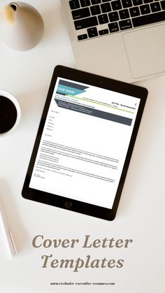 a tablet computer sitting on top of a white desk next to a cup of coffee