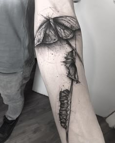 a black and white photo of a tattoo on the arm