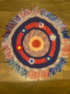 a round rug with many different colors and designs