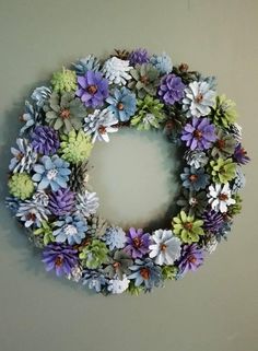 a wreath made out of fake flowers hanging on the wall