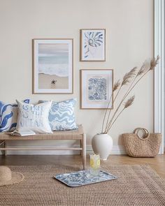 a living room filled with furniture and pictures on the wall