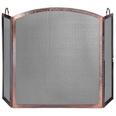 an old fashioned fireplace screen with metal mesh