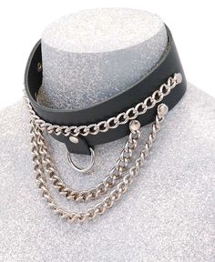 Chain choker necklace in heavy cowhide and chrome. This multi-chain leather choker with adjustable back snaps to fit most men and women. It is 1 3/8" wide cowhide leather choker fits a 14 1/2" to 15 1/2 " neck. This chain choker comes with two bottom swooping chain, a center nickel plated chain, and a center D-ring to attach other hardware if needed. Made with heavy 7-8 oz. cowhide leather. Made in USA. [1#] IMPORTANT SPECIFICATIONS: MADE IN USA: This item is American Made and hand crafted by our Jamin Leather's® talented sewing and manufacturing staff or company partner. No one makes quality leather accessories quite like Jamin Leather. LEATHER: Cowhide is a standard premium quality skin that is soft and supple to the touch. The grain is more even across all the panels of the product. The Adjustable Punk Style Chain Choker, Edgy Leather Choker Jewelry, Edgy Leather Choker, Adjustable Edgy Leather Choker, Punk Leather Jewelry For Festivals, Punk Leather Jewelry For Concerts, Edgy Leather Jewelry For Festivals, Edgy Leather Jewelry For Concerts, Gothic Leather Jewelry For Festival