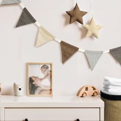 a white dresser topped with pictures and stars