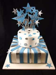 a blue and white birthday cake with stars on the top that says 21st happy scott