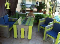 an outdoor table and chairs with blue cushions