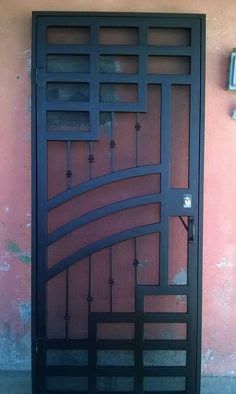 an iron gate on the side of a building