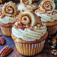 several cupcakes with white frosting and pecans