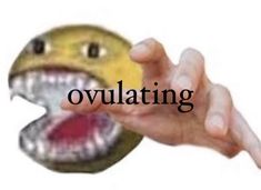 a hand holding an object with the word ovulating in front of it