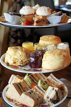 three tiered trays filled with cakes and pastries