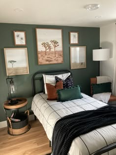 a bedroom with green walls and pictures on the wall