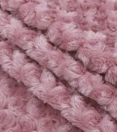 the texture of a pink blanket is made up of fluffy, fuzzy yarn and crochet