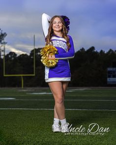 a girl in a cheer uniform holding a pom - pom on the football field