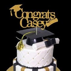 a graduation cake with a black and white striped design on top that says congrats casey