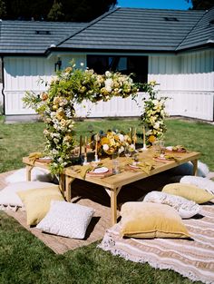 a picnic table with flowers and candles on it