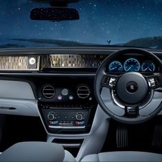 the interior of a car with dashboard lights and steering wheel