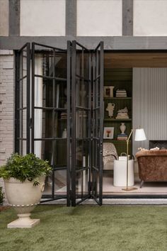 an open living room with glass doors and furniture