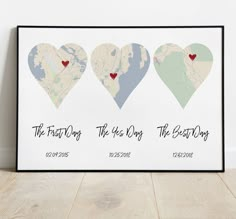 three heart shaped maps with the names and date on them, sitting in front of a white wall