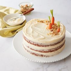 a carrot cake sitting on top of a white plate