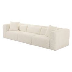 a white couch with four pillows on the back and one pillow in the middle, against a white background