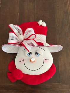 a red and white stuffed animal wearing a hat