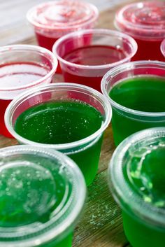 several cups filled with green and red liquid