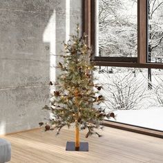 a small christmas tree sitting on top of a wooden floor