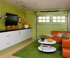 a living room filled with furniture and a flat screen tv mounted to the side of a wall