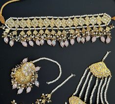 This lightweight and dainty set in thapa kundan or multani work is made of high quality gold plating and has gorgeous pink crystal drops that have an ombre finish. The colors are super unique and pastel so that they can go with any outfit whether its a saree or lehenga! and can be worn separately for a simple look. This lightweight and elegant necklace is perfect for any bridesmaid, bride, sangeet or any occasion or event as a gift for any occasion as any one who loves jewelry will love this sta Pink Kundan Sets With Cutdana, Pink Kundan Wedding Set, Gold Stone Work Sets For Eid, Gold Sets With Stone Work For Eid, Bollywood Style Pink Tikka With Stone Work, Pink Festive Sets With Stone Work, Pink Elegant Kundan Tikka, Elegant Pink Kundan Tikka, Gold Kundan Sets For Eid