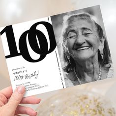 a woman holding up a birthday card with the number ten on it