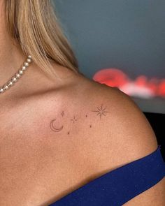 the back of a woman's shoulder with two stars and a crescent on it