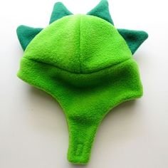 a close up of a green hat on a white surface