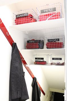 the closet is full of clothes and other items for storage, including baskets on shelves