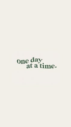 the words one day at a time are written in green ink on a white background